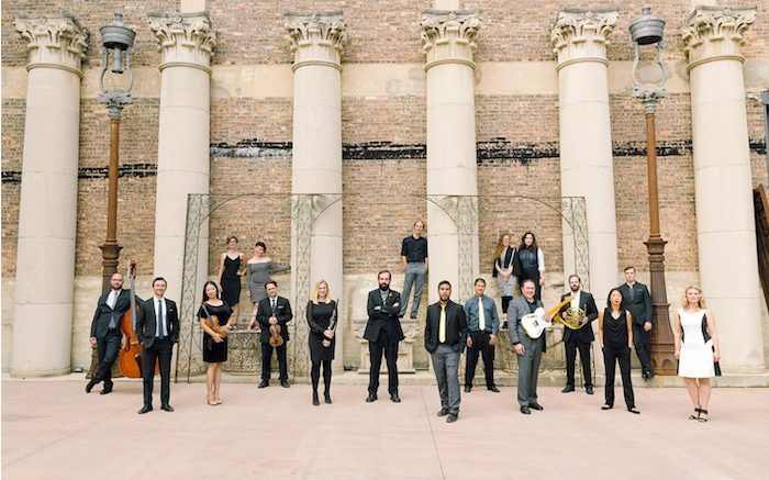 Members of Ensemble Dal Niente standing on front of tall Corinthian columns.