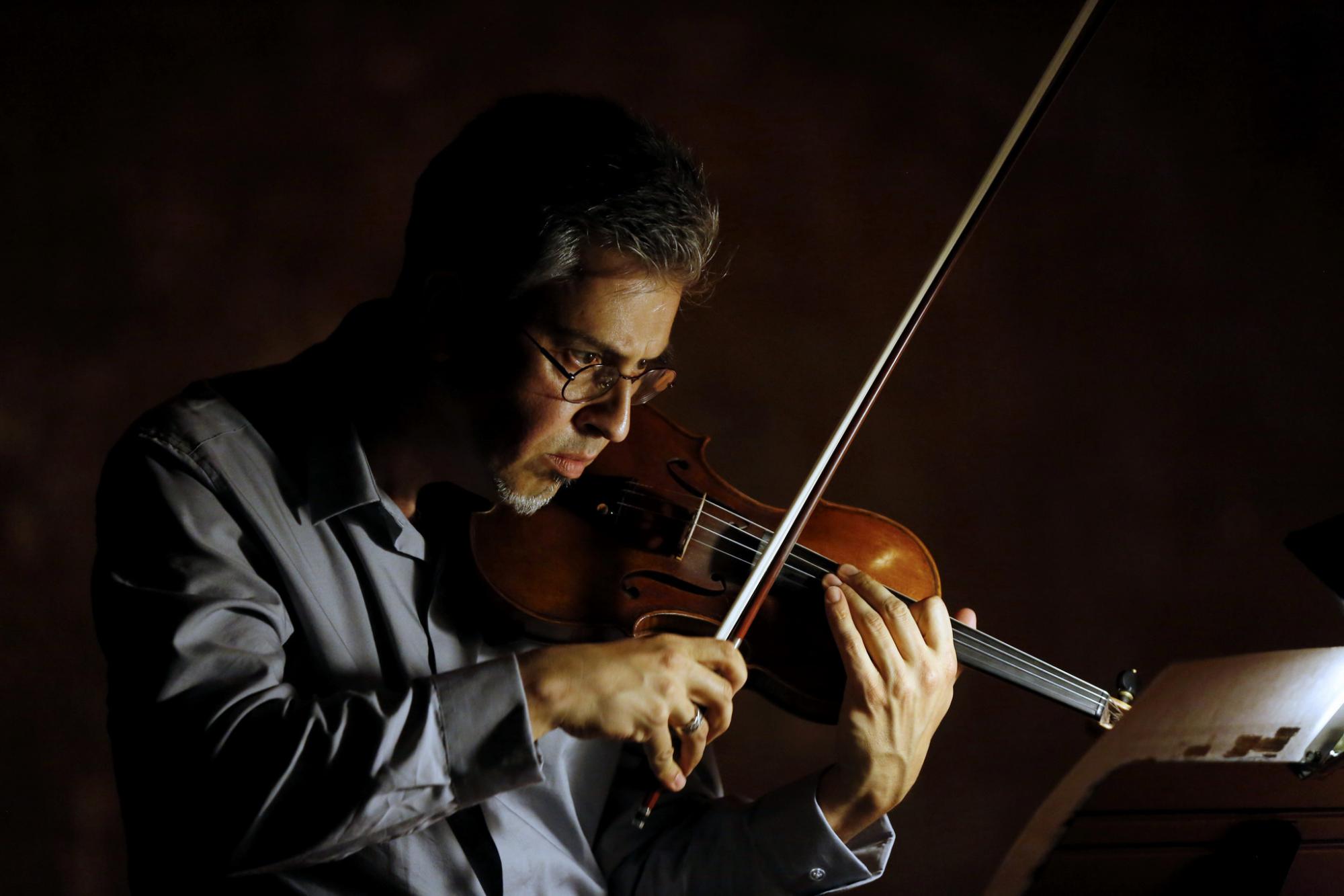 Mark Menzies playing the violin.