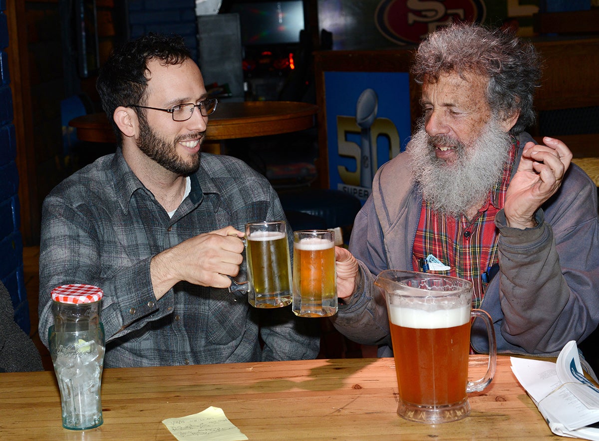 Jacob Montgomery toasts a beer with Art Shapiro.