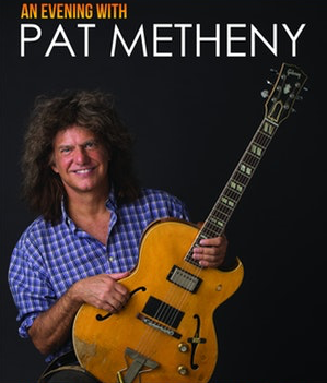 Pat Metheny holding his guitar.