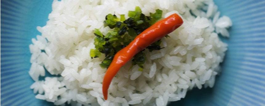 Rice on a plate with a pepper and green sauce