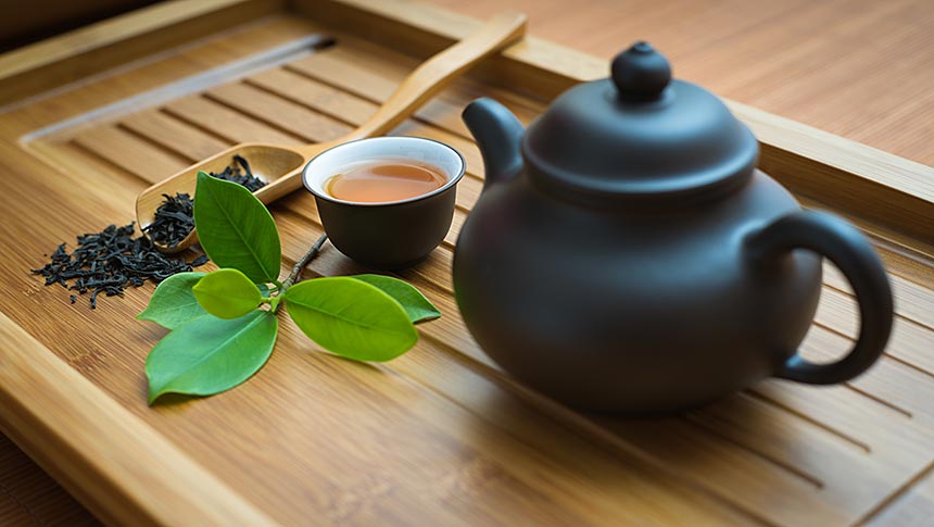 Bamboo tray holds tea leaves and teapot