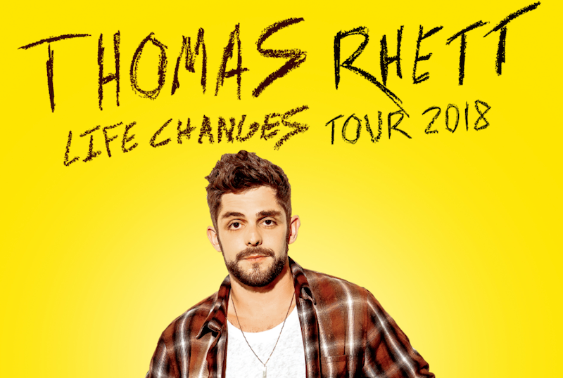 SInger Thomas Rhett standing in front of a yellow background.